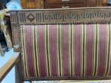 a wooden chair with a striped upholstered seat