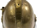 brass colored helmet on a white surface with a white background