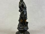 bronze figurine of a woman with a basket of flowers