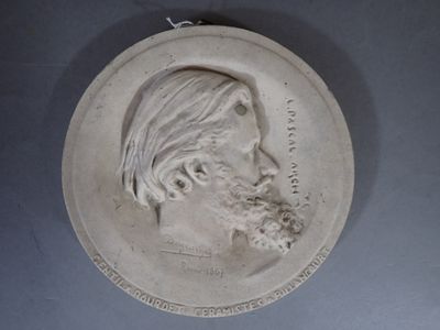 a plaque of a man with a beard on the wall