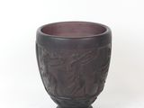 a brown cup with a design on it