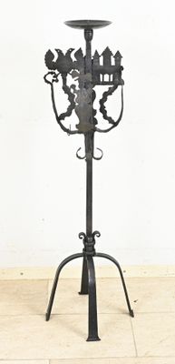 wrought iron candelab with a bird and flower design on the top