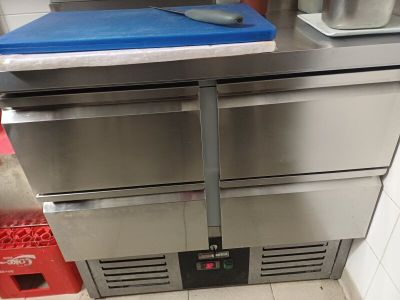une planche à découper bleue posée sur un four en acier inoxydable