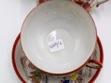 a cup and saucer sitting on a saucer with a tag on it