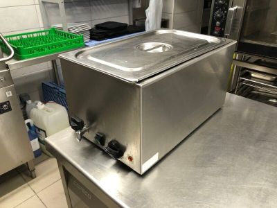stainless steel counter top in a commercial kitchen with a pan on it