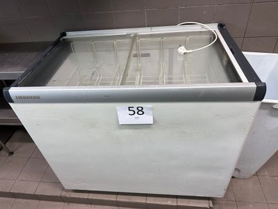 a freezer that is sitting on the floor in the kitchen
