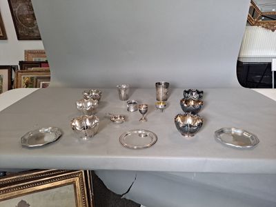 a table with a lot of silver items on it