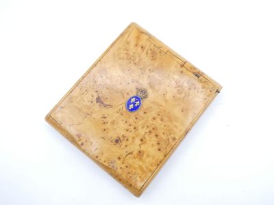 a small wooden box with a blue button on it