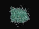a pile of green crushed glass on a black surface