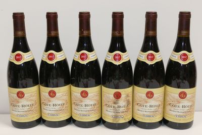 six bottles of red wine are lined up on a table
