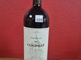 a bottle of red wine sitting on a wooden table