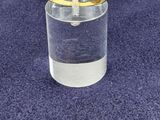 a glass with a ring on it sitting on a blue carpet