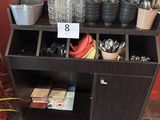 a shelf with pots and pans on it in a room