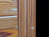 a cat that is looking out of a door