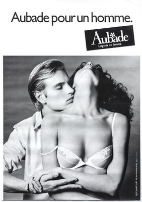 an advertisement for a women ' s underwear ad featuring a woman kissing a man