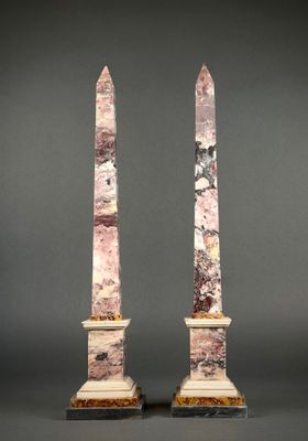 a pair of pink marble obelisks on marble bases