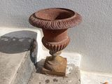 a small vase sitting on the steps of a building