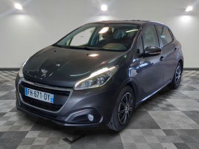 the grey car is parked on a checkered floor in the garage