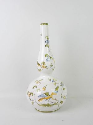 a white vase with a bird design on it