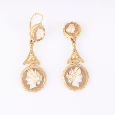 an image of a pair of earrings with a woman ' s profile
