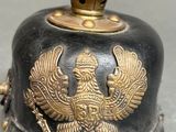 a black and gold helmet with a bird on it