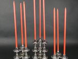 un lot de six bougeoirs en verre avec des bougies rouges