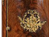 a wooden cabinet with a gold decoration on the front
