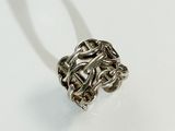 a close up of a silver ring on a white surface