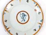 a white plate with a blue and orange design on it