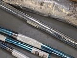 several baseball bats are wrapped in plastic and sitting on a table