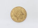 a close up of a gold coin on a white surface