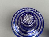 a blue glass bottle with a flower inside of it