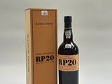 a bottle of wine sitting next to a cardboard box