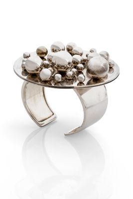 a close up of a silver ring on a white surface