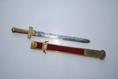 two knives are sitting on top of each other on a white surface