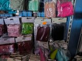 many bags of different colored items in a store
