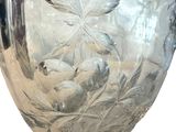 a clear glass vase with a leaf design on it