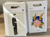 two boxes with stickers of a man and a woman in a tuxedo