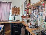 a kitchen with a lot of clutter on the counter