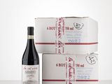 two boxes of wine and a bottle of wine sitting on a table