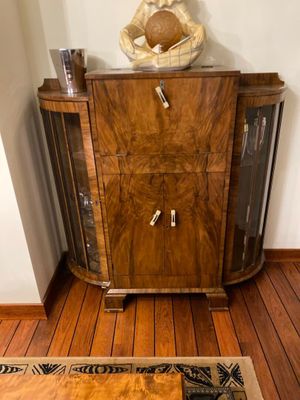 an image of a living room with wood floors and a wooden cabinet