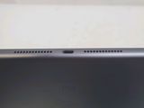 the back of a black tablet computer sitting on top of a table