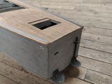 a small wooden box on wheels on a wooden floor