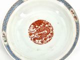 a plate with a dragon on it sitting on a table