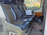 four seats in the back of a van with a laptop on it