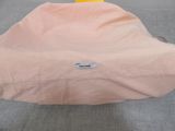 a pink bean bag sitting on the floor next to a yellow chair