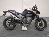 a motorcycle that is parked on a checkered floor