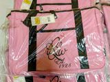 a pink bag that is wrapped in plastic on the floor