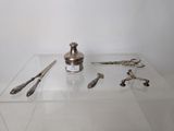 a glass display case with silver objects on it