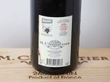 a bottle of wine sitting on top of a wooden box